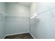Spacious walk-in closet with built-in shelving and wood-look flooring at 1813 Sw 157Th Place Rd, Ocala, FL 34473