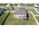 This aerial view shows the home's large backyard, fenced perimeter, and inviting covered patio area at 1861 Ne 50Th Ter, Ocala, FL 34470