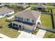 This aerial view highlights the home’s cozy front porch, long driveway, and fully fenced yard at 1861 Ne 50Th Ter, Ocala, FL 34470