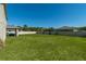 Expansive backyard with lush green grass, a white fence, and mature trees at 1861 Ne 50Th Ter, Ocala, FL 34470