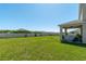 Expansive backyard featuring a well-kept lawn, enclosed by a secure fence, and covered patio at 1861 Ne 50Th Ter, Ocala, FL 34470