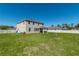 Spacious backyard showcasing a two-story home, well-maintained lawn, and privacy fencing at 1861 Ne 50Th Ter, Ocala, FL 34470