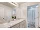 Bright bathroom featuring a double sink vanity, large mirror, and separate shower/toilet room at 1861 Ne 50Th Ter, Ocala, FL 34470