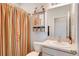 Bright bathroom with colorful shower curtain, functional toilet, and vanity with ample storage at 1861 Ne 50Th Ter, Ocala, FL 34470