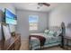 Cozy bedroom features a comfortable bed, dresser, and mounted TV for relaxation at 1861 Ne 50Th Ter, Ocala, FL 34470