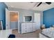 Bedroom boasts a large dresser with mirror, closet, and carpet flooring for a comfortable retreat at 1861 Ne 50Th Ter, Ocala, FL 34470