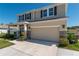 Two-story home with stone accents, a two-car garage, manicured bushes, and a well-maintained lawn at 1861 Ne 50Th Ter, Ocala, FL 34470