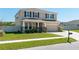 Two-story home with a two-car garage, covered front porch, manicured lawn, and neutral color palette at 1861 Ne 50Th Ter, Ocala, FL 34470
