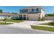 Two-story home with a neutral color palette, featuring a two-car garage, covered porch, and well-maintained landscaping at 1861 Ne 50Th Ter, Ocala, FL 34470