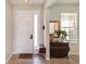 Bright foyer with tile flooring, a decorative table, and a mirror to create a welcoming entryway at 1861 Ne 50Th Ter, Ocala, FL 34470