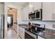 Modern kitchen features granite countertops, stainless steel appliances, white subway tile backsplash and recessed lighting at 1861 Ne 50Th Ter, Ocala, FL 34470
