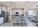 Modern kitchen features granite countertops, pendant lighting, stainless steel appliances, and tile flooring at 1861 Ne 50Th Ter, Ocala, FL 34470