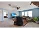 Cozy living room with plush seating, TV, ceiling fan, and natural light from several windows at 1861 Ne 50Th Ter, Ocala, FL 34470