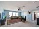 Bright living room featuring comfortable seating, a ceiling fan, and a large TV for entertaining at 1861 Ne 50Th Ter, Ocala, FL 34470