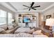 Spacious living room featuring a ceiling fan, entertainment center, and comfortable sectional sofa at 1861 Ne 50Th Ter, Ocala, FL 34470