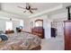 The main bedroom features carpet flooring, a ceiling fan, walk in closet, and work space at 1861 Ne 50Th Ter, Ocala, FL 34470