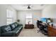 Well-lit office with a sofa, desk, dual monitors, and a ceiling fan at 1861 Ne 50Th Ter, Ocala, FL 34470