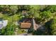 Aerial shot of a home with a brown roof surrounded by lush trees on a large lot at 2130 Sw 37Th Street Rd, Ocala, FL 34471