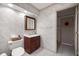 Neutral wallpaper complements this bathroom with a wood vanity and mirror cabinet at 2130 Sw 37Th Street Rd, Ocala, FL 34471