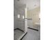 A modern bathroom featuring a glass shower and decorative black and white tiled floors at 2130 Sw 37Th Street Rd, Ocala, FL 34471