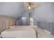 This bedroom has an angled ceiling with a walk-in closet and hardwood floors at 2130 Sw 37Th Street Rd, Ocala, FL 34471