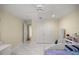 Spacious bedroom with a ceiling fan, marble floors, and walk-in closets at 2130 Sw 37Th Street Rd, Ocala, FL 34471