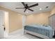 A spacious bedroom with marble floors, ceiling fan, and an ensuite bathroom at 2130 Sw 37Th Street Rd, Ocala, FL 34471
