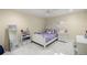 Bright bedroom with a ceiling fan, white furniture, and marble floors at 2130 Sw 37Th Street Rd, Ocala, FL 34471