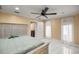 Bright bedroom featuring marble flooring, a ceiling fan, and ensuite access at 2130 Sw 37Th Street Rd, Ocala, FL 34471