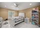 Cozy bedroom features a ceiling fan and plush bedding at 2130 Sw 37Th Street Rd, Ocala, FL 34471