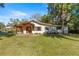 A home with a covered front porch, well-manicured lawn, and plenty of trees at 2130 Sw 37Th Street Rd, Ocala, FL 34471