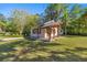 Charming home featuring a well-maintained lawn and a covered front porch with support columns at 2130 Sw 37Th Street Rd, Ocala, FL 34471