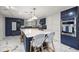 Modern kitchen featuring a large island with seating, white countertops, and stainless steel appliances at 2130 Sw 37Th Street Rd, Ocala, FL 34471