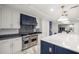 Gourmet kitchen featuring a Viking range, custom cabinetry, and a large island with bar seating at 2130 Sw 37Th Street Rd, Ocala, FL 34471