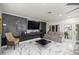 Open-concept living room with marble floors and modern media center at 2130 Sw 37Th Street Rd, Ocala, FL 34471
