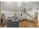 Bright living room with vaulted ceilings, a staircase, hardwood floors, and stylish furnishings at 2130 Sw 37Th Street Rd, Ocala, FL 34471