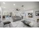 Bright living room featuring a comfortable gray sofa, marble flooring, and an open floor plan to the dining area at 2130 Sw 37Th Street Rd, Ocala, FL 34471