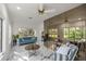 Bright, airy sitting room featuring a mirrored wall, marble flooring, and views of the outdoor greenery at 2130 Sw 37Th Street Rd, Ocala, FL 34471
