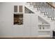 This well-designed living space features a built-in bar with wine storage and display shelves under the staircase at 2130 Sw 37Th Street Rd, Ocala, FL 34471