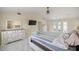 Bright main bedroom with French doors, ensuite, ceiling fan and large dresser at 2130 Sw 37Th Street Rd, Ocala, FL 34471