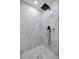 Modern shower featuring marble tile, a rainfall shower head, and sleek black fixtures at 2130 Sw 37Th Street Rd, Ocala, FL 34471