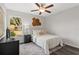 Comfortable bedroom with fan, window, a vintage rug, and classic furnishings at 22 Fisher Way Pass, Ocklawaha, FL 32179