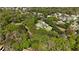 Aerial shot of a large property featuring a home with a pool surrounded by tall mature trees at 2881 Se 41St Pl, Ocala, FL 34480