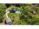 An aerial perspective of a pristine home with a pool, complemented by lush, mature trees at 2881 Se 41St Pl, Ocala, FL 34480