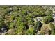 An aerial view of a home with a pool nestled among trees in a serene setting at 2881 Se 41St Pl, Ocala, FL 34480