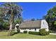 Side view of a barn featuring garage doors, a ladder, and a well-maintained landscape at 2881 Se 41St Pl, Ocala, FL 34480