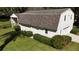 Angle view of barn with two garage doors and lush green lawn with manicured shrubbery at 2881 Se 41St Pl, Ocala, FL 34480