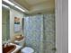 Standard bathroom with a shower and toilet, with blue and white patterned shower curtains at 2881 Se 41St Pl, Ocala, FL 34480