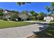 Long driveway leading to a white home with a matching two-car garage and a barn at 2881 Se 41St Pl, Ocala, FL 34480