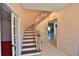 Elegant foyer with curved staircase, chandelier, and views into the dining area and a nearby room at 2881 Se 41St Pl, Ocala, FL 34480
